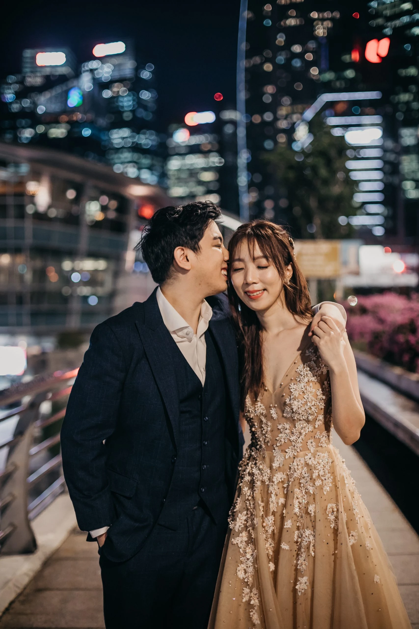 Min and Gabriel smiling in an urban setting