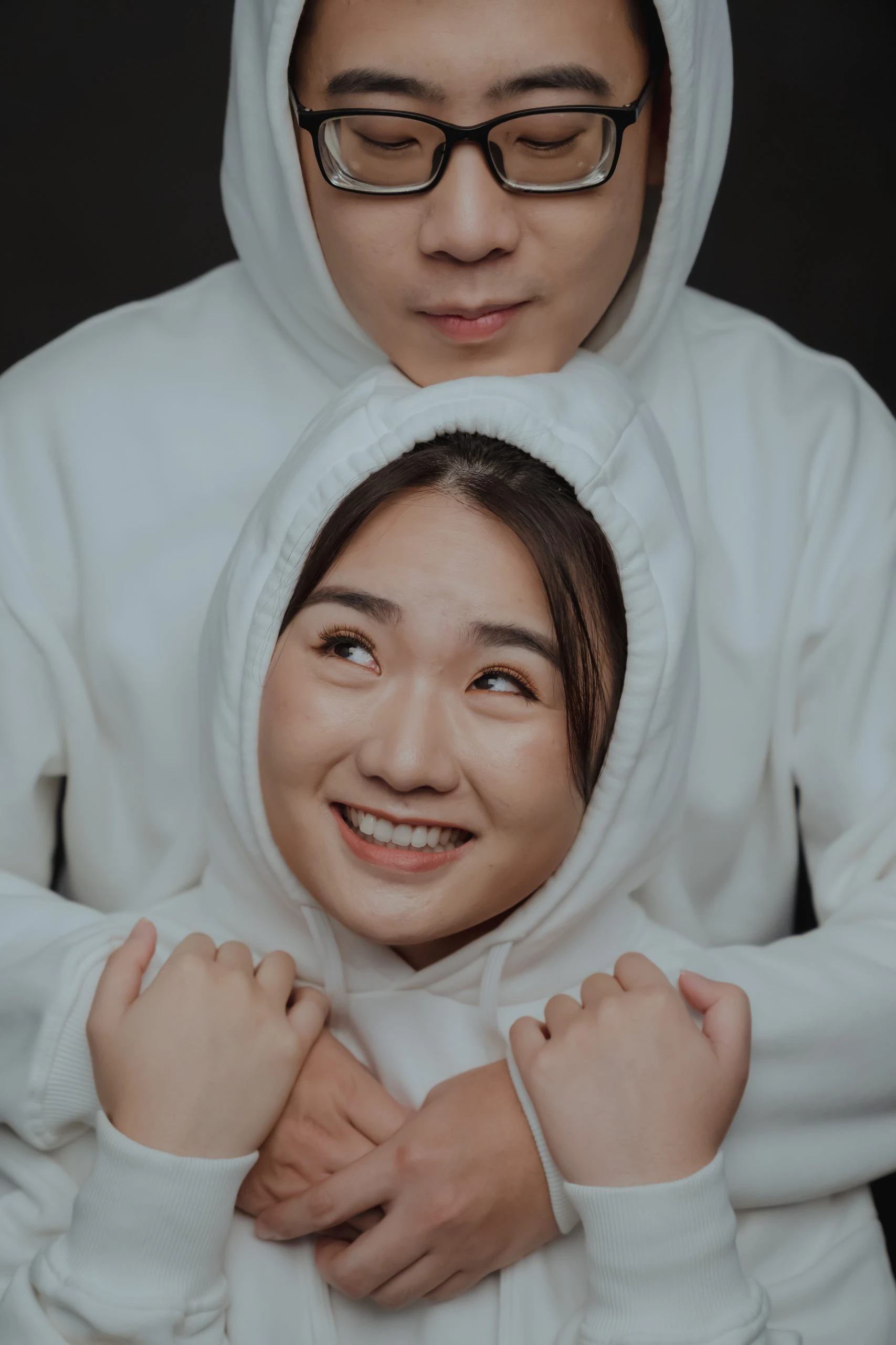 Ya Quan and Wang Yi posing in soft evening light